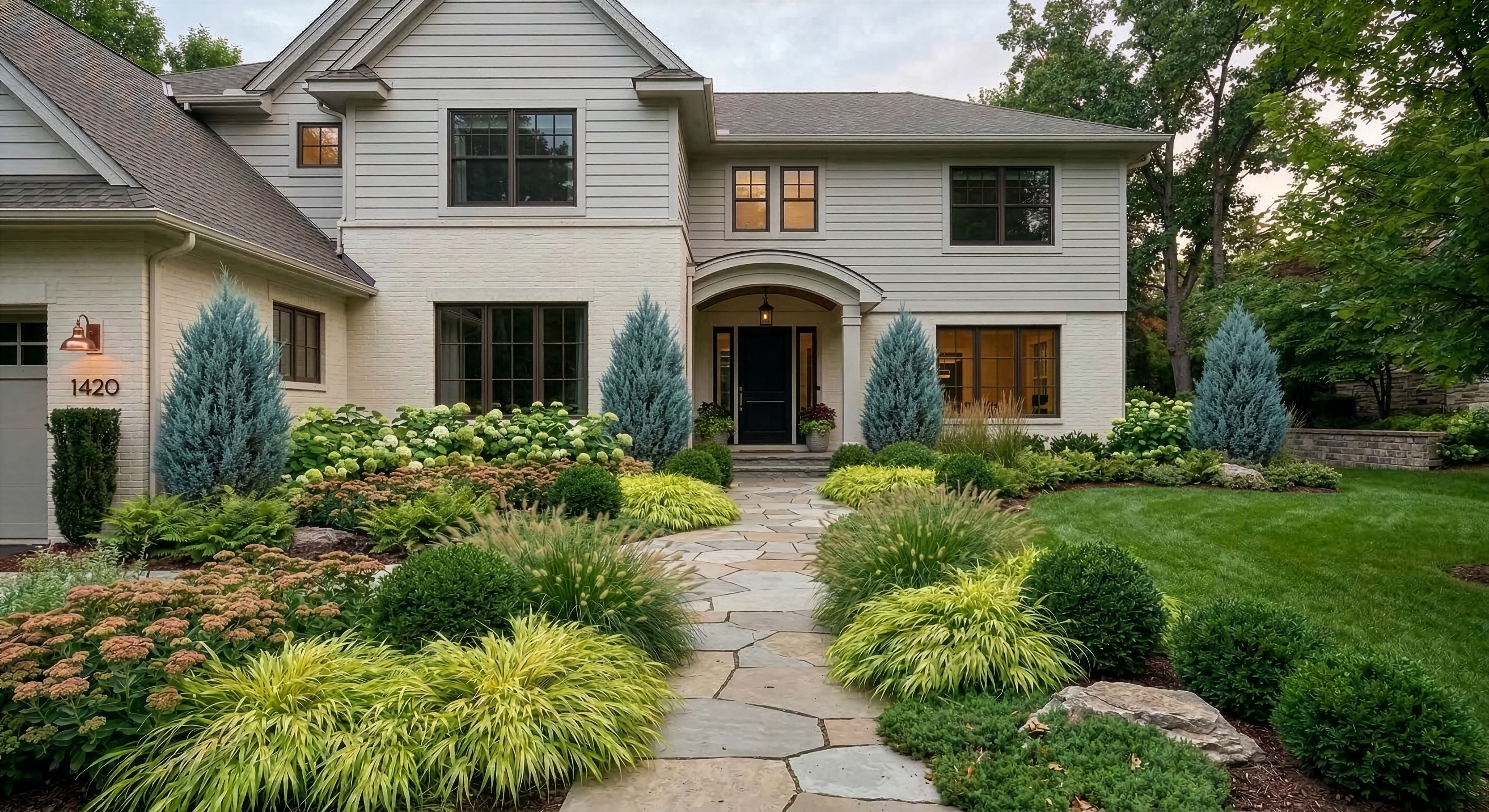 A cared-for home with a clean lawn, layered planting, and a clear front path.