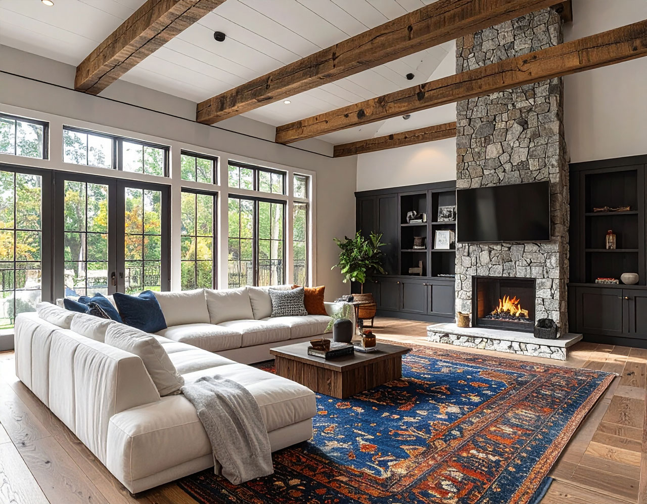 A cared-for great room with clean surfaces, built-ins, and a stone fireplace.